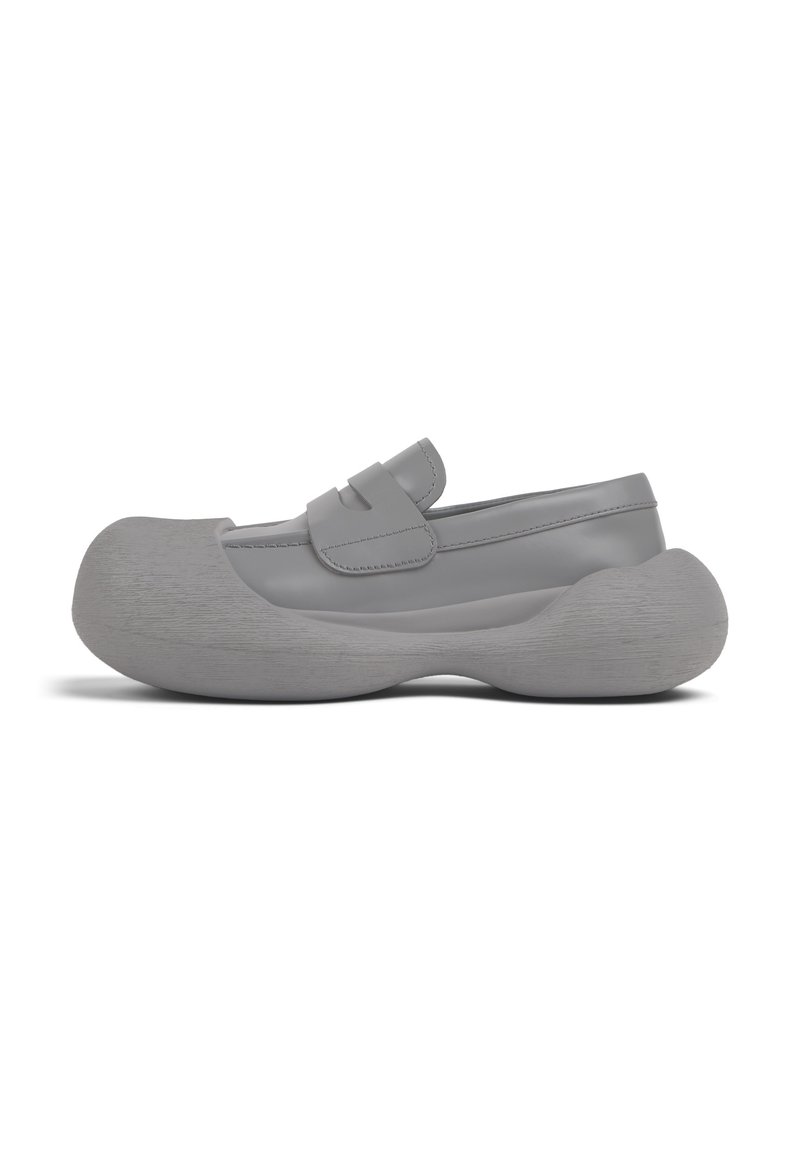 Gray rubber slip-on shoes with a rounded toe, textured gray sole, and a strap across the instep. Smooth upper with stitched detailing.