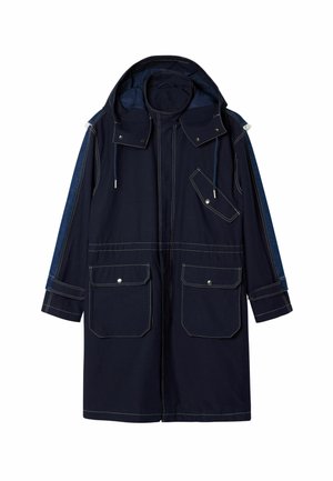 Navy blue coat with a hood, featuring two large front pockets, denim-accented sleeves, and contrasting white stitching. Durable fabric design.