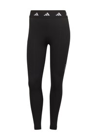 Czarne legginsy wykonane z elastycznego materiału z wysokim stanem, ozdobione trzema białymi logo adidas. Minimalistyczny design, gładka tekstura.