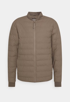 Ruskea puffatakki, jossa on korkea kaulus, pystysuuntainen tikkauskuvio, etuvetoketju ja ribbireunat, valmistettu kevyestä kankaasta.