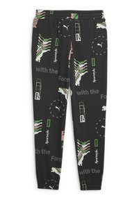 Svarta joggers med ett upprepande mönster av gröna, rosa och vita grafik, inklusive logotyper och stiliserade mönster. Elastisk midja.