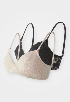 Three lace bras in black and soft pink. The black one has an intricate floral pattern, while the pink features a scalloped edge.