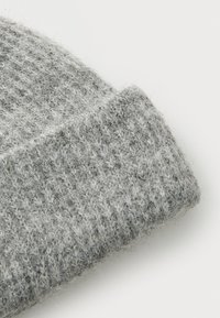 Gray knitted fabric with a textured pattern. The material appears soft and fuzzy, featuring a light and dark gray color blend.