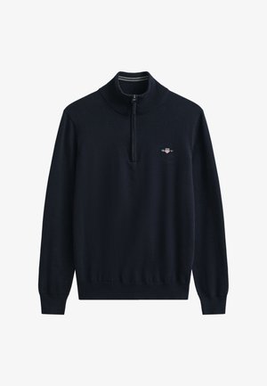 Tengerészkék pulóver puha kötött anyagból, félcipzáros nyakkal, bordázott mandzsettákkal és egy kis hímzett logóval a mellkason.