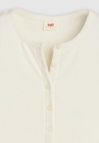 Άσπρο ριμπ μπλουζάκι henley με στρογγυλή λαιμόκοψη, διαθέτει τέσσερα κουμπώματα και ετικέτα Levi's στο εσωτερικό κολάρο.