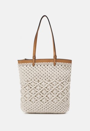 Beige woven tote bag with intricate macramé pattern and brown leather handles against a plain background.
