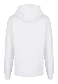 White hoodie with a soft fabric texture, featuring a drawstring hood, long sleeves, and a ribbed hem. No visible branding or patterns.