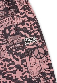 Black-and-pink patterned fabric featuring various graphics, including text, faces, and symbols, with stitched "grimmy" label.