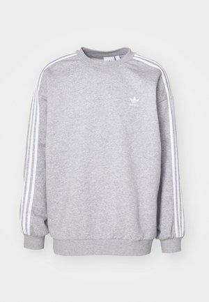 Grå sweatshirt i bomullsblandning, har långa ärmar, hög rund hals och tre vita ränder längs varje axel.