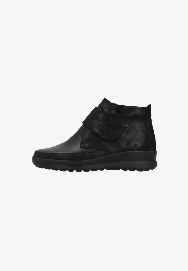 Black ankle boot featuring a combination of smooth leather and textured suede, with a Velcro strap and a rubber sole for traction.