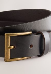 Black leather belt with a rectangular brass buckle, featuring a smooth texture and punch holes for adjustment. Accented with a smaller leather loop.