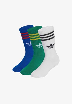 Three pairs of athletic socks: blue with red stripes, green with yellow stripes, and white with black stripes. Each features brand logo.