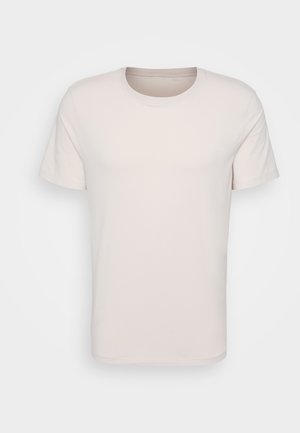 Kurze Ärmel T-Shirt aus leichtem beigen Baumwollstoff, mit einem klassischen Rundhalsausschnitt und einer glatten, weichen Textur ohne sichtbare Muster.