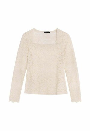 Haut à manches longues en dentelle de couleur blanc cassé, avec un décolleté carré et des bords festonnés. Motif floral délicat sur l'ensemble du tissu.