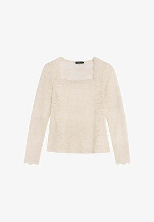 Haut à manches longues en dentelle de couleur blanc cassé, avec un décolleté carré et des bords festonnés. Motif floral délicat sur l'ensemble du tissu.