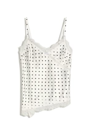 Weißes Unterhemd mit schwarzen Punkten, Spitzenbesatz entlang des Ausschnitts und Saums sowie dünnen verstellbaren Schulterträgern.