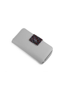 Light gray faux leather wallet with a black snap closure featuring colorful polka dots. Smooth texture and rectangular shape.