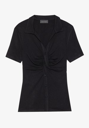 Black short-sleeve top with a collared neckline, gathered detailing at the front, and a button closure. Made from ribbed fabric.