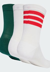 Tri para nogavic: ena zelena, ena bela z rdečimi črtami in ena povsem bela. Kaneliran tekstura, dolžina do sredine teleta in ojačani peti.