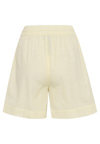 Shorts décontractés jaune clair avec taille élastique et coupe ample, en tissu léger, vus de dos sur fond blanc.