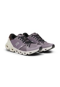 Athletic shoes with a lavender and black mesh upper, white cushioning sole, black laces, and logo accent on the side.