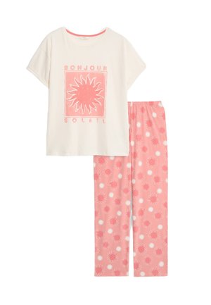 Light pink pajama set featuring a cream short-sleeve top with a sun graphic and matching pants with sun patterns. Soft cotton material.