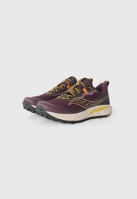 Trail running shoes in dark purple and gold accents, featuring a textured mesh upper, contrasting beige speckled sole, and rugged black tread.