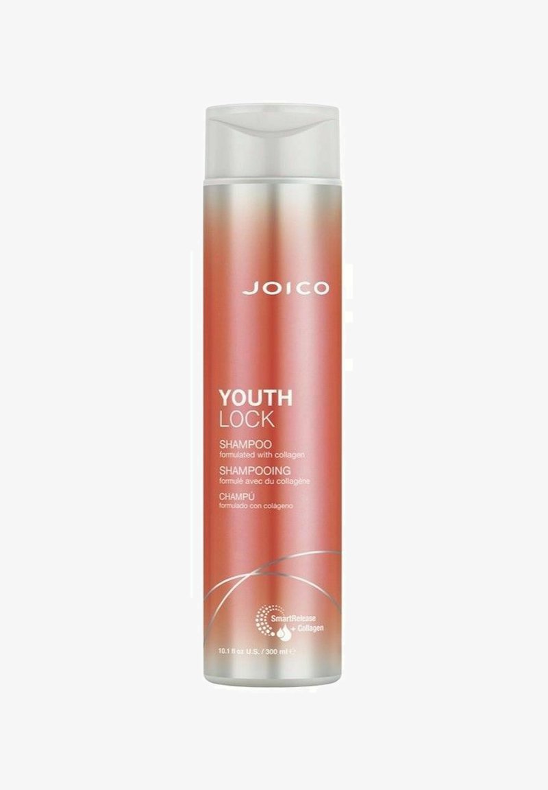 Joico Youth Lock Shampoo is in a tall, cylindrical, opaque bottle with a gradient finish from rose gold to silver and features a flip-top lid.