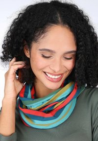 Multicolored infinity scarf featuring bold stripes in teal, red, green, and yellow. Soft fabric with a smooth texture.