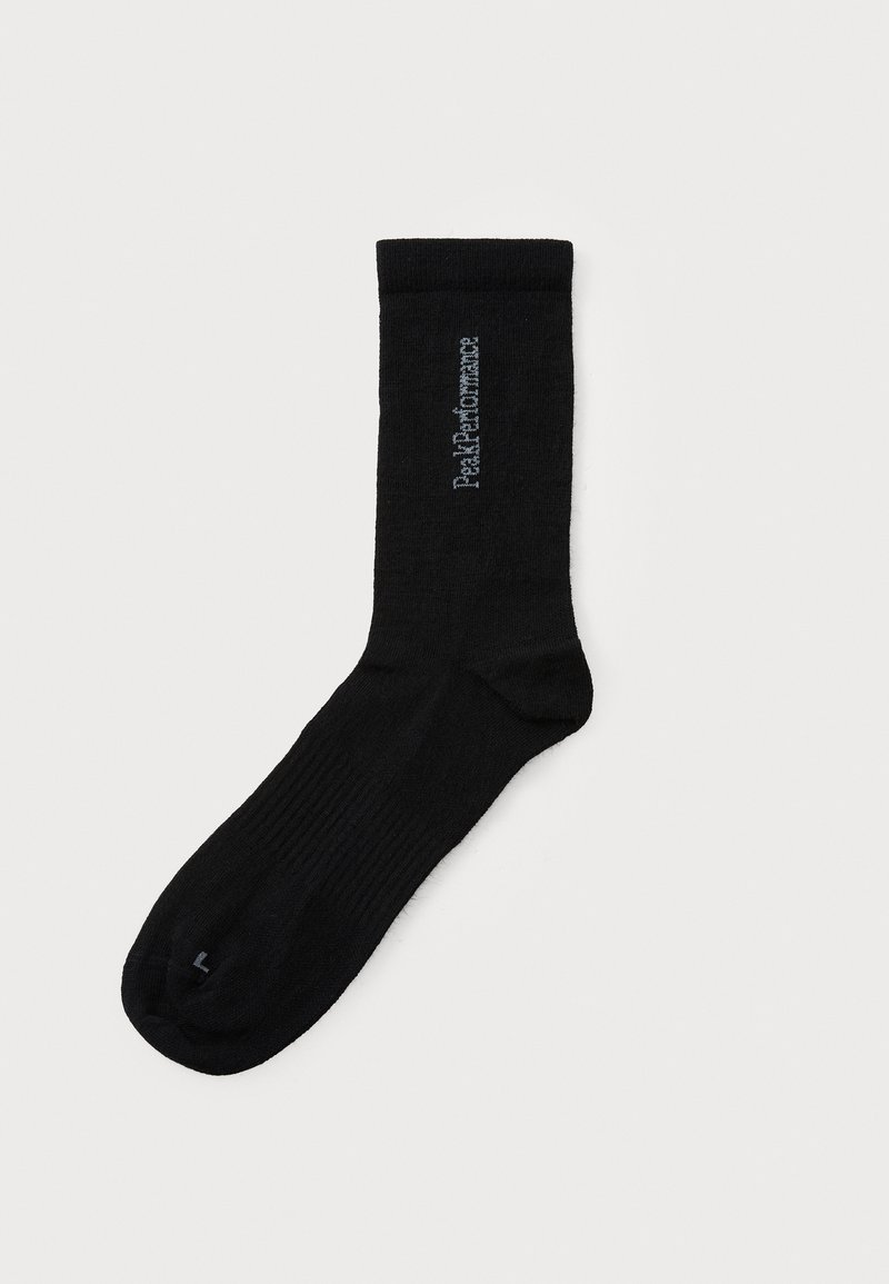Black knee-length sock made of soft fabric, featuring ribbed texture and a small light gray logo on the side.