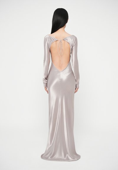 Saténové dlhé šaty s dlhým rukávom v svetlosivej farbe. Majú hlboký výstrih na chrbte so zaväzovaním, priliehavý strih a hladkú, lesklú textúru.