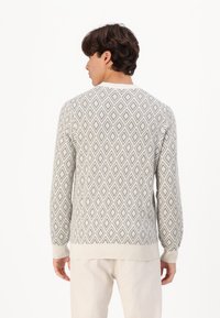 Light gray sweater featuring a diamond pattern in darker gray, ribbed cuffs, and a crew neckline, made from a soft, textured fabric.