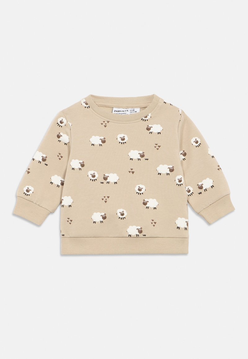 Bež pulover iz mešanice bombaža, s patterned ovacami in rjavimi poudarki. Okrogla izreza, rebraste manšete in spodnji rob.