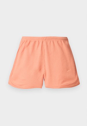 Shorts de sport roses à côtes avec une taille élastique et des coutures latérales, présentant un petit logo en bas à gauche sur le devant.
