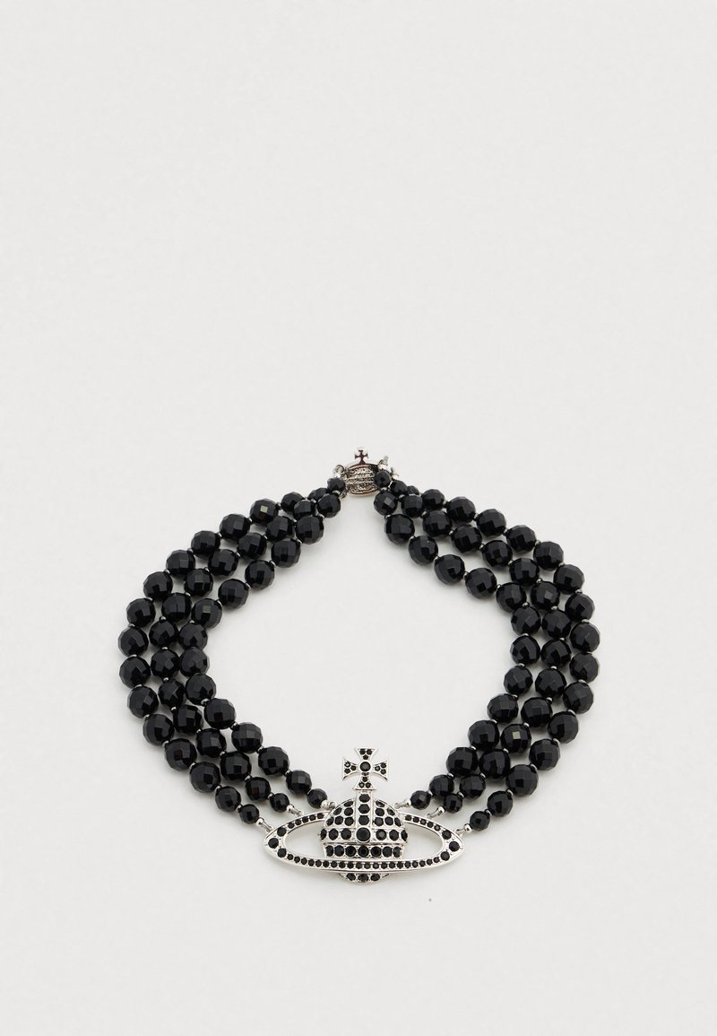 Μαύρο κολιέ με χάντρες πολλαπλών σειρών, με ένα π ερίτεχνο ασημένιο μενταγιόν σε σχήμα κορώνας διακοσμημένο με μαύρες πέτρες.