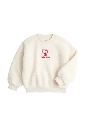 Sahnefarbener Sherpa-Fleece-Pullover mit roter Hello Kitty-Stickerei in der Mitte der Brust sowie gerippten Bündchen und Saum.