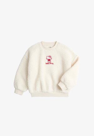 Sudadera de forro polar sherpa color crema con un bordado rojo de Hello Kitty centrado en el pecho y puños y dobladillo acanalados.