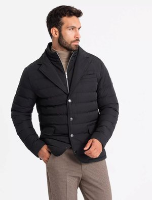Black puffer jacket with a tailored design, featuring a notched collar, front buttons, and two side pockets. Worn over a beige turtleneck.