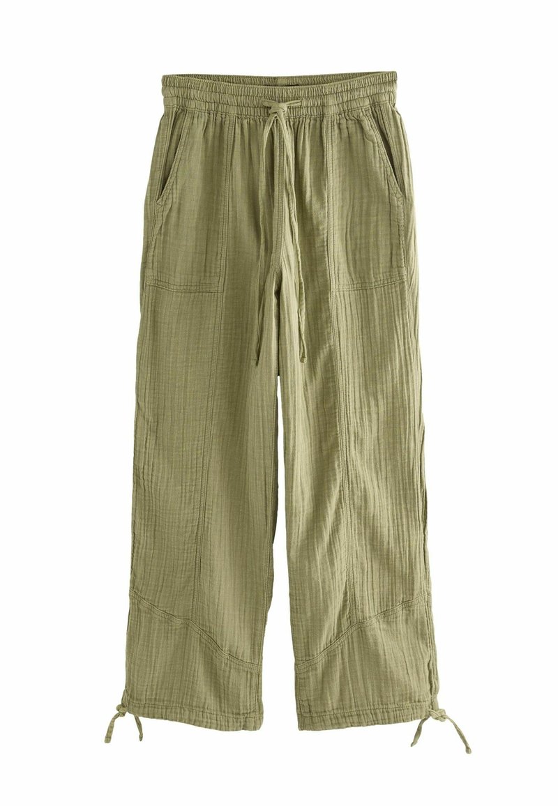 Pantaloni larghi verde chiaro realizzati in tessuto testurizzato, con vita elastica, cordoncino e tasche laterali. L'orlo presenta lacci regolabili.