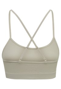 Ljusbeige sport-bh med en texturerad yta, med tunna, korslagda spännen och ett brett band. Utan vaddering eller byglar, sömlös design.