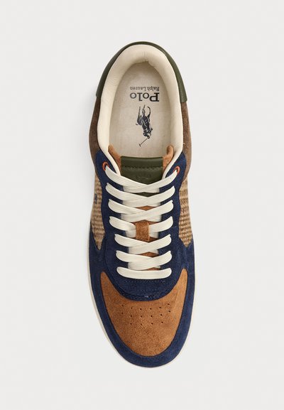 Brown and navy suede sneaker with cream laces, green accents, and a patterned design. Features a cushioned insole and perforated toe.