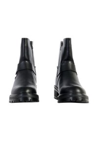 Black leather ankle boots with a smooth texture, side zippers, and a thick, rugged sole. Features a broad strap across the upper.