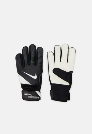Gants de gardien noir et blanc avec une prise texturée, un poignet élastique et des paumes rembourrées. Présente le logo Nike et une sangle ajustable.