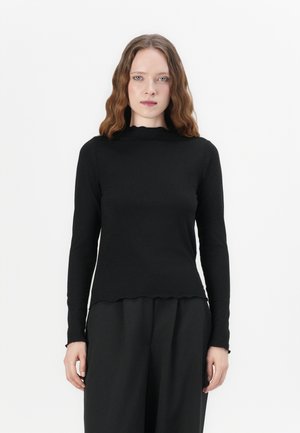 Black long-sleeve ribbed top with a scalloped neckline and hem. The fabric appears soft and textured, forming a fitted silhouette.