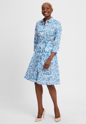 Hemdblusenkleid mit blauem Muster, langen Ärmeln, tailliertem Bund und knielangem Rock. Aus leichtem Stoff mit floralem Design gefertigt.