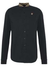 Camicia nera a maniche lunghe con colletto dorato decorato, chiusura frontale con bottoni e un logo sottile sul petto. Tessuto liscio e design aderente.