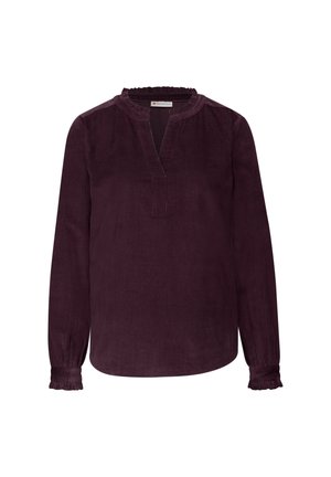 Blusa de pana color ciruela de manga larga con escote en V y cuello con volantes. Presenta puños fruncidos y un corte relajado para mayor comodidad.