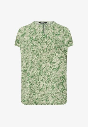 Grøn kortærmet top med et blomstermønster i lysere grøn. Den har en rund halsudskæring og en lille slids foran.