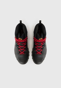Bottes de randonnée noires avec une tige en cuir texturé et en mesh. Lacets et détails en métal rouge vif. Semelle en caoutchouc robuste pour une meilleure adhérence.
