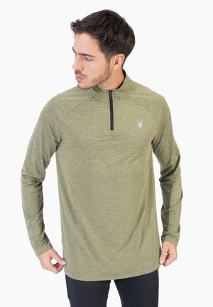 Grünes Langarmshirt mit einem Viertel-Reißverschluss, strukturiertem Stoff und einem Logo auf der Brust. Verfügt über Raglanärmel und einen geraden Saum.